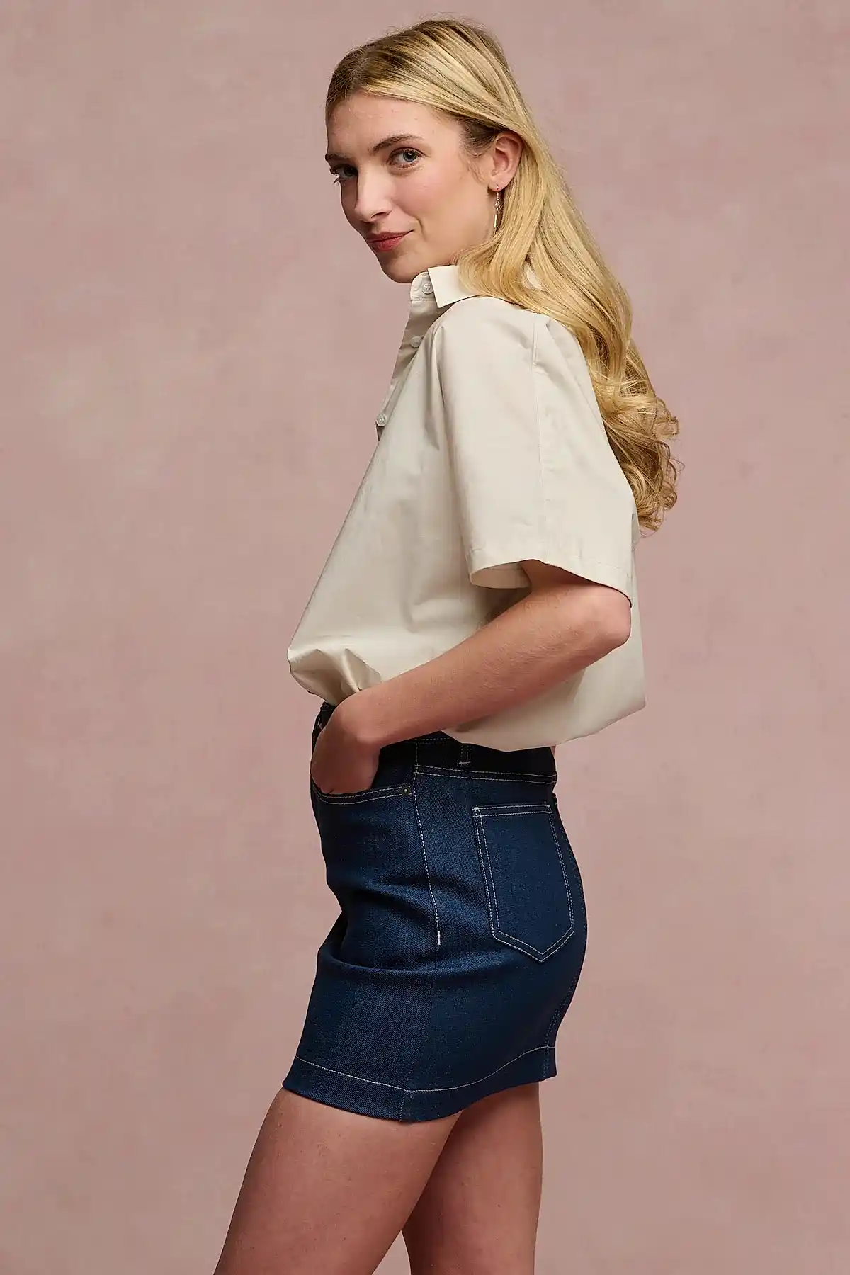 The side of female wearing Charlie denim mini skirt in blue with stone Ava shirt