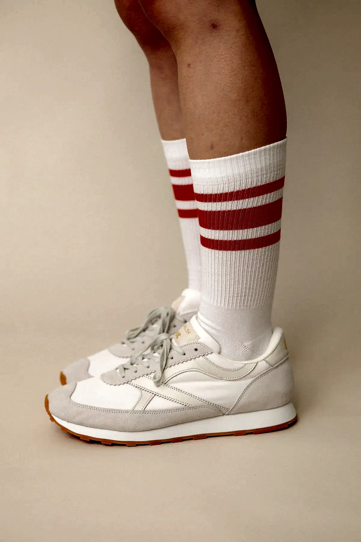 Model wearing calf sports sock in white with flame red stripe wearing Wlash X Community Clothing Beacon trainers